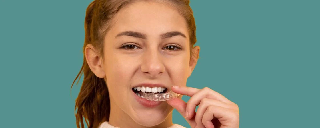 Photo of girl using clear teeth braces