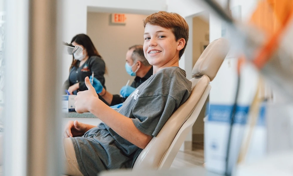 Photo of young boy being happy about his dental treatment